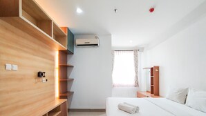 A modern bedroom with a wooden bed, built-in shelves, a wardrobe, and an air conditioning unit.