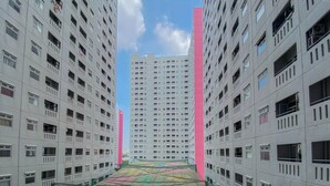 A high-rise building with multiple floors, featuring balconies and windows. - Good Choice And Homey 2Br At Green Pramuka City Apartment (Jakarta)