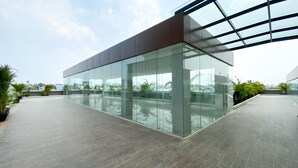 A modern building with large glass windows and a flat roof. - Good Choice Studio Apartment Anwa Residence Bintaro (South Tangerang)
