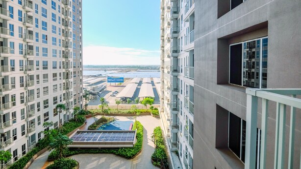 A high-rise building with multiple balconies and a rooftop pool area. - Spacious 2Br Combined Tokyo Riverside Pik 2 Apartment (Teluknaga)