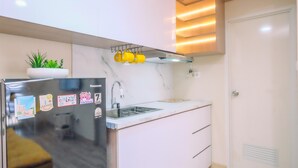 A modern kitchen with a built-in refrigerator, a sink, and a countertop. - Spacious 2Br Combined Tokyo Riverside Pik 2 Apartment (Teluknaga)