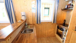 A compact kitchen with wooden countertops, a sink, a coffee maker, and a stove. - Chalet in Stadl an der Mur near Ski Slopes (Stadl an der mur)