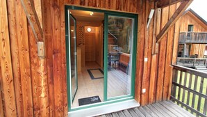 A wooden cabin with a glass door leading to an interior space. - Chalet in Stadl an der Mur near Ski Slopes (Stadl an der mur)
