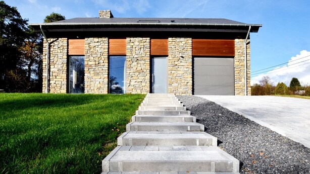 A modern house with stone and wood exterior, large windows, and a concrete staircase leading to the front door. - Cosy Holiday Home in Durbuy with Garden (Durbuy)