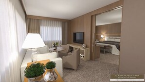 A hotel room with a seating area, a TV, and a bed. - White Plaza Hotel (Curitiba)