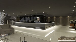A modern reception area with a marble counter, a staircase, and a minimalist decor. - White Plaza Hotel (Curitiba)