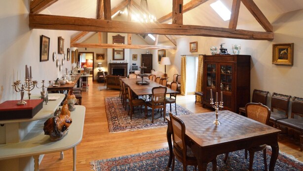 A spacious dining area with wooden beams, a high ceiling, and a chandelier. - Cosy Cottage in Barvaux-Condroz with Garden (Barvaux Condroz)
