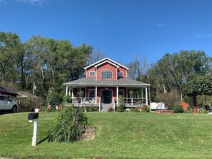 Stunning two-story house with a charming front porch and beautifully manicured lawn.