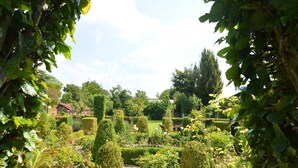 A well-maintained garden with various plants and a gravel path. - Comfortable Home with Sauna (Vloesberg (flobecq))