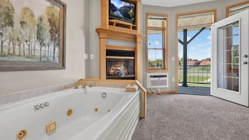 Deluxe Suite | Living area | 32-inch LED TV with cable channels, DVD player