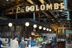 A busy café interior with a prominent sign reading "La Colombie".