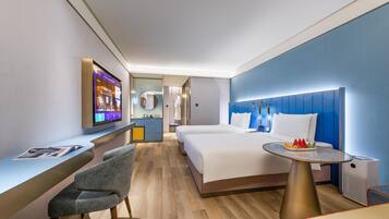 A modern hotel room with a bed, bedside table, and a TV.