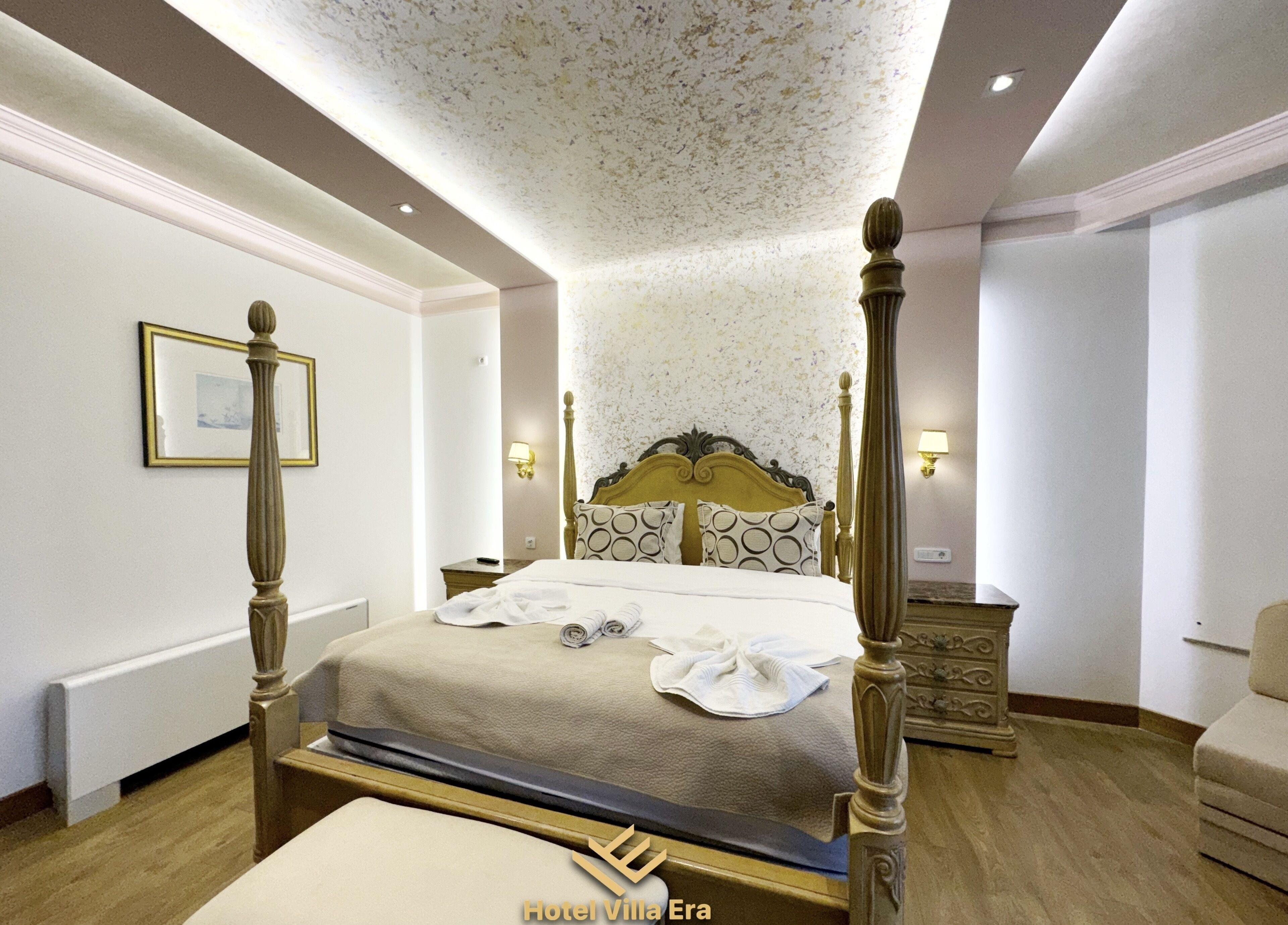 A four-poster bed with a headboard, bedside tables, and a nightstand.
