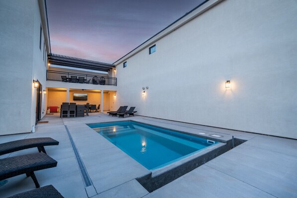 A heated pool - Spacious Brand New Home! Lots of courtyard space and fun for all. (Hurricane)