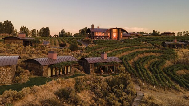 A vineyard estate with stone buildings, a large central house with a curved roof, and terraced vineyards. - Sagecliffe Resort & Spa (Quincy)