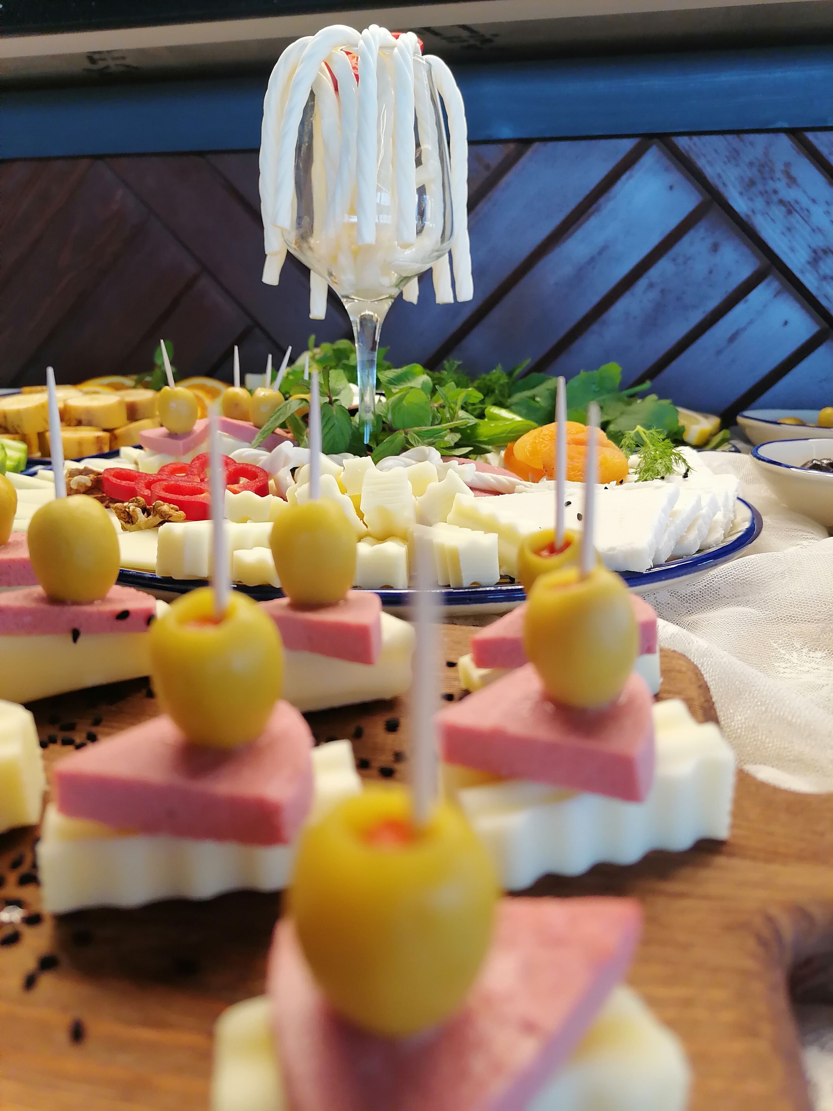 A buffet with various food items including cheese, fruits, and nuts.