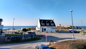 A coastal building with a sign reading 'La Plage.' - Apartment 'Guillaume' with Sea View (tregunc)