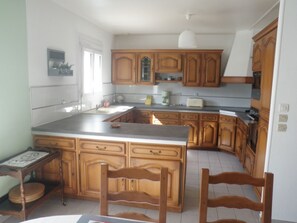 Enjoy cooking in this well-equipped kitchen with a large island and modern design.