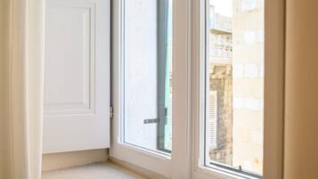 A corner window with a book on the ledge.