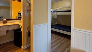 A compact room with a bunk bed, a small kitchenette with a countertop and sink, and a mirror with lights. - 2 Bedroom PET-FRIENDLY Family Suite at Ocean-Side Property! (Monterey)