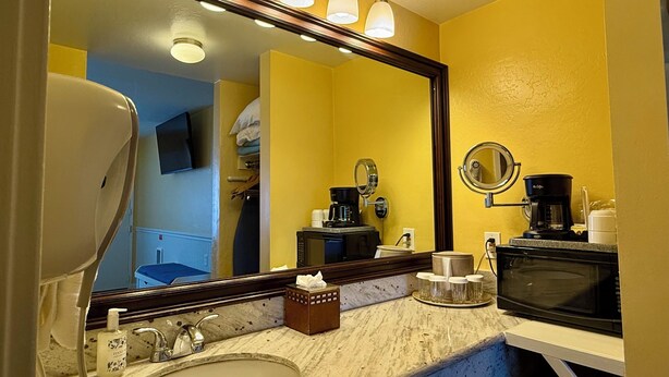 A bathroom with a sink, mirror, and a coffee maker. - 2 Bedroom PET-FRIENDLY Family Suite at Ocean-Side Property! (Monterey)