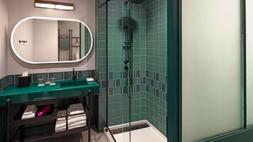A modern bathroom with a glass-enclosed shower, a vanity with a green countertop, and a large mirror.