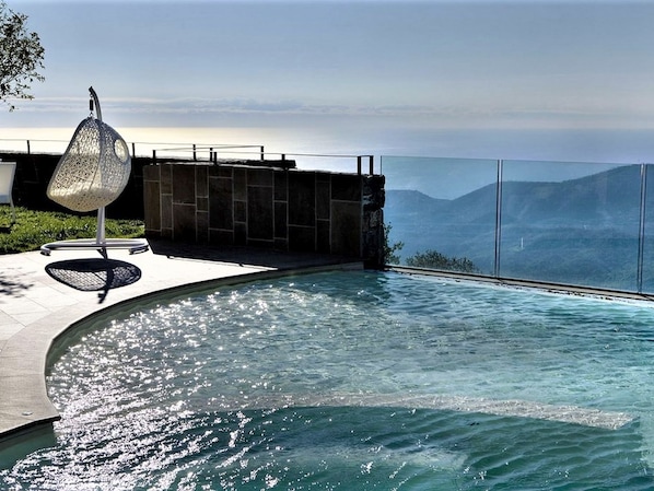 An infinity pool with a clear view of the mountains in the background.