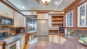 A modern kitchen with granite countertops, stainless steel appliances, and wooden cabinetry. - Spacious Jamestown Home Near Nat'l Comedy Center! (Jamestown)