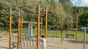 A playground with a climbing structure, swings, and a slide. - Charming Tuscan Farmhouse (Ortignano)