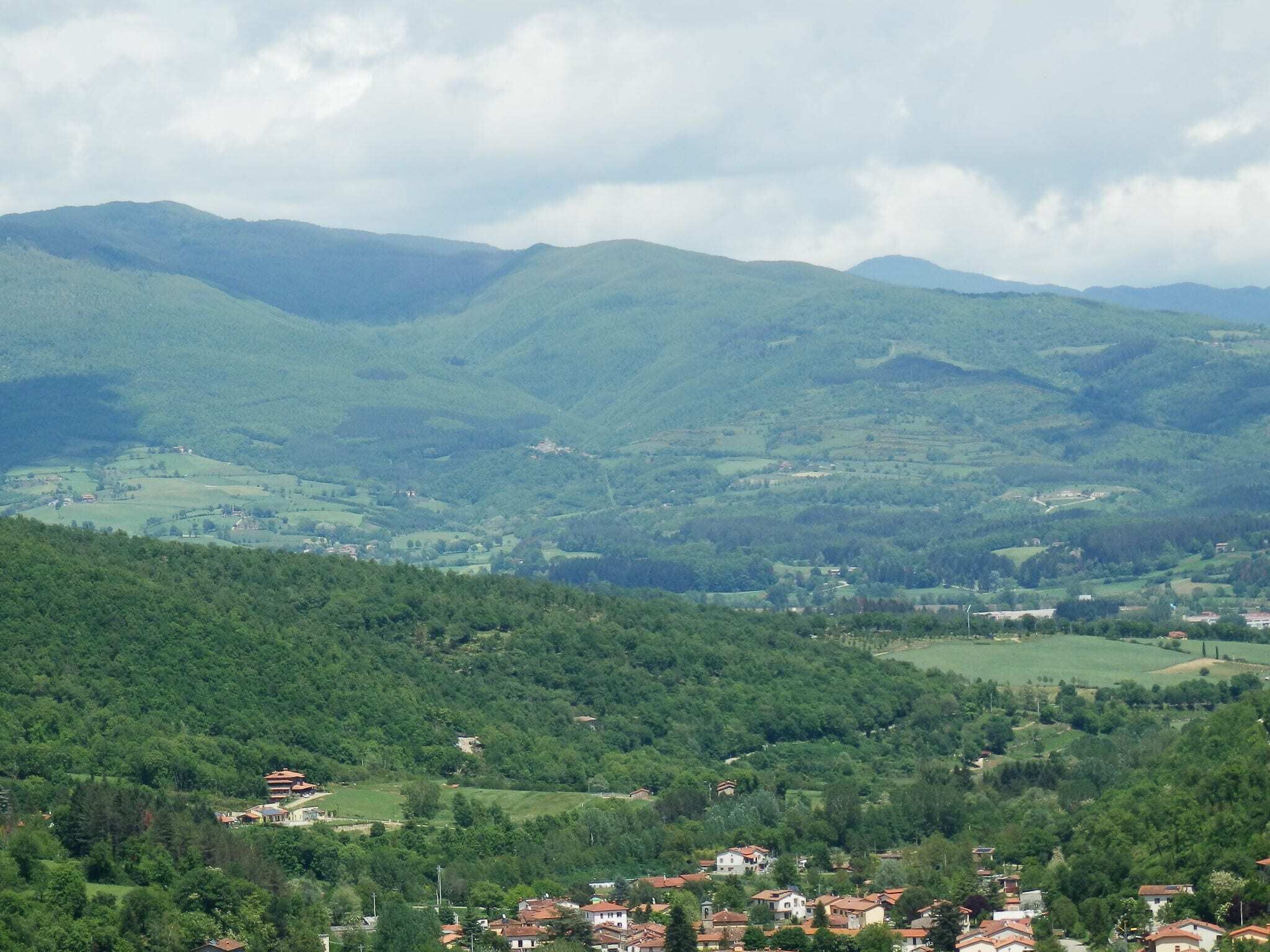 A mountainous landscape with scattered buildings.