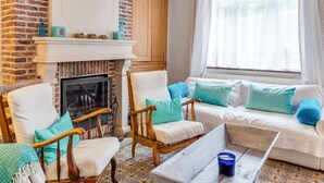 A cozy living room with a fireplace, two armchairs, a sofa, and a coffee table. - Charming Stay in Viroinval (Viroinval)