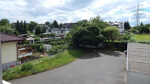 A residential area with houses, a paved road, and a large tree. - Holiday Apartment 'Haus Abendsonne Upper Floor Small' with Shared Terrace, Balcony and Wi-Fi (Koblenz)