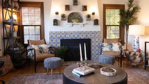 A cozy living room with a fireplace, patterned tiles, and a coffee table. - Cozy family home minutes from The University of Puget Sound! (Tacoma)