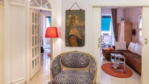 A living room with a zebra-patterned sofa, a red lamp, and a framed artwork on the wall. - Apartment in Rome with balcony (Roma)