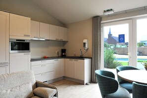 Fridge, microwave, stovetop, dining tables