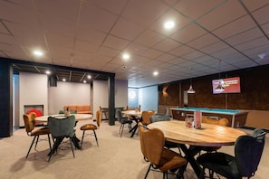 Relax in style with a pool table and comfortable seating, perfect for socializing and entertainment.