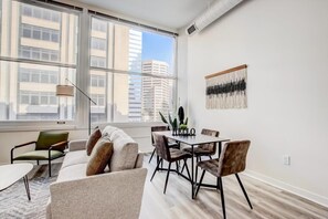 Apartment | Living area | 42-inch Smart TV with digital channels, Netflix, Hulu - CozySuites The Block Skybridge Access (Indianapolis)