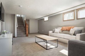 TV, books - Upscale Modern Oasis: Spacious & Chic with HotTub! (Traverse City)