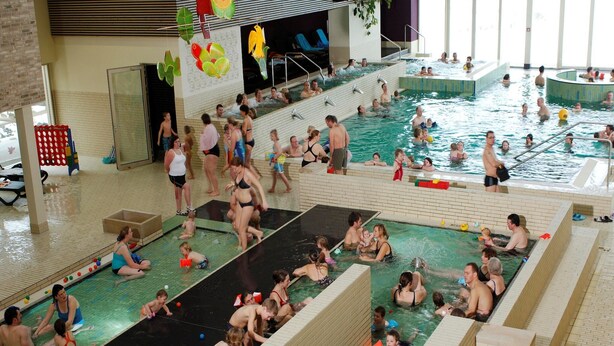 A large indoor swimming pool with multiple lanes and a separate shallow play area for children. - Holiday Villa with Garden (Bad Bentheim)