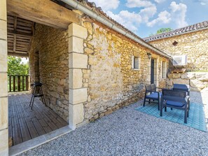 A stone building with a wooden deck and outdoor seating. - Renovated farmhouse in Soturac with pool (Soturac)