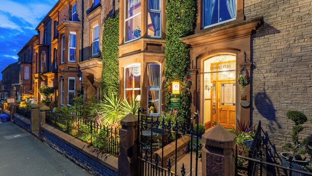 A row of traditional brick townhouses with a pub named "Brooklands" on the right. - Brooklands Guest House  (Penrith)