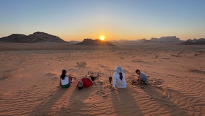 A desert landscape with a sunset. - Milky Way Nights Camp (Wadi Rum)
