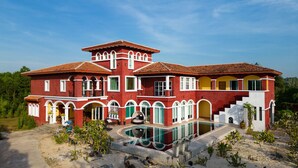 A large, multi-story house with a swimming pool, surrounded by greenery. - Hacienda Resort Mae Phim (Klaeng)