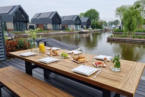 Dine with a view of the canal and its boats.