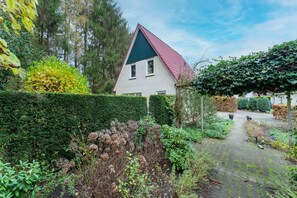 Surrounded by a serene garden, this charming house offers a peaceful retreat.