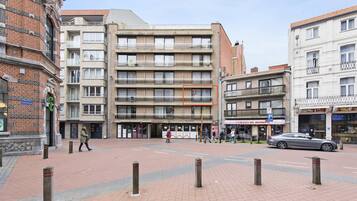 A multi-story building with a brick facade and a flat roof.