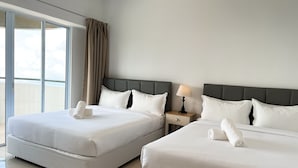 A hotel room with two beds, a nightstand with a lamp, and a large window with curtains. - Cloud Forest Homestay Genting Highlands (Genting Highlands)