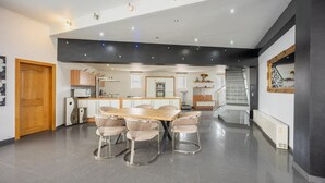 A modern kitchen with a central island, dining table, and chairs. - Holiday Home in Verviers with Sauna (Verviers)