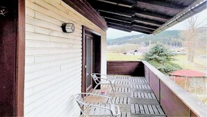 A wooden building with a porch, a door, and a small window. - Chalet in Flattnitz near Ski Slopes & Lakes (Karnten)