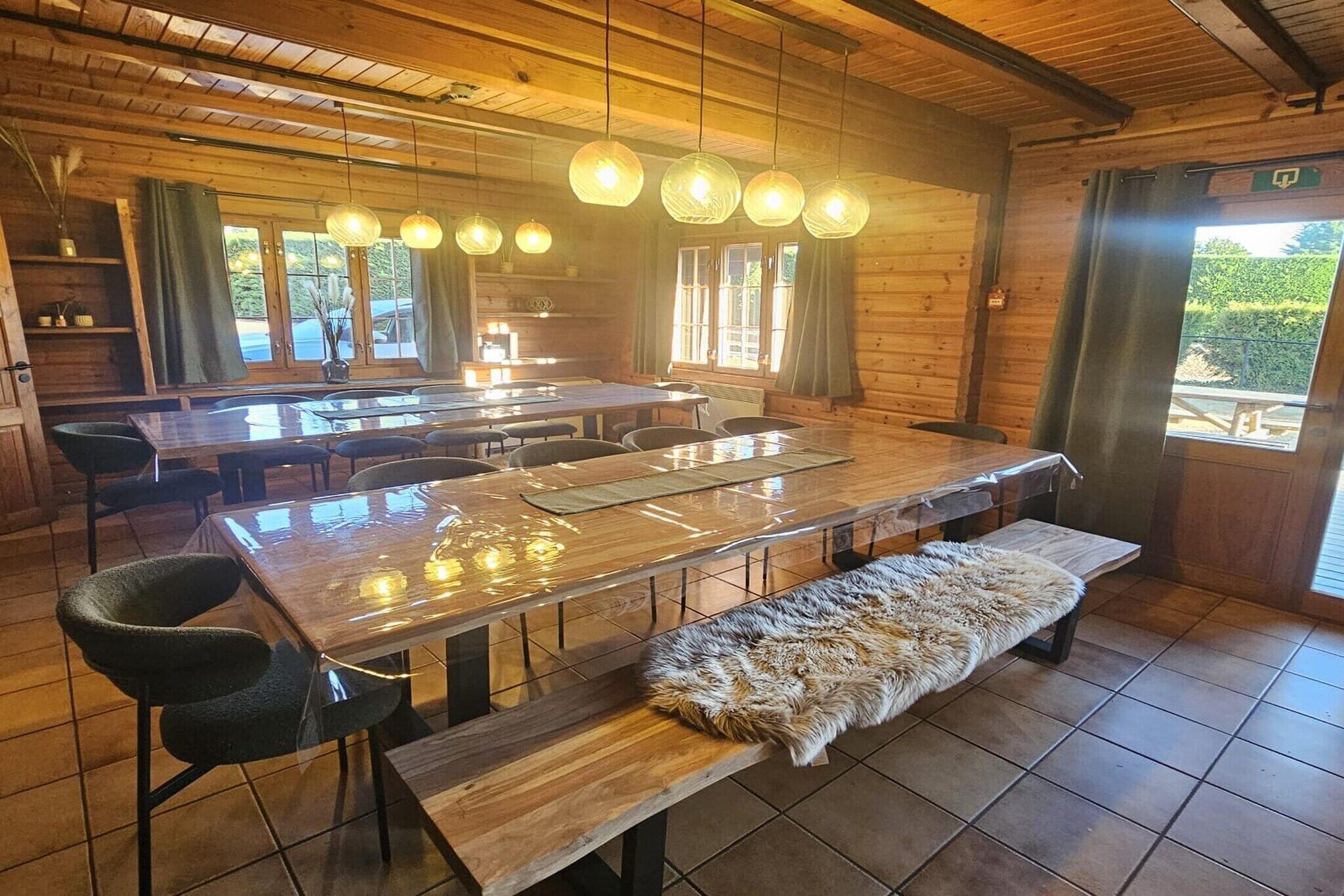 A wooden interior with a dining area, benches, and a fur-covered bench.